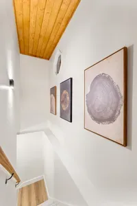 Bright stairwell with wood accents and stylish gallery-style wall art