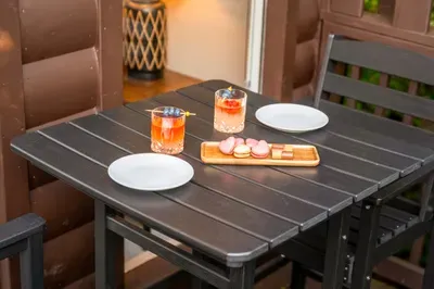 Cozy private patio setup with cocktails and seating for two