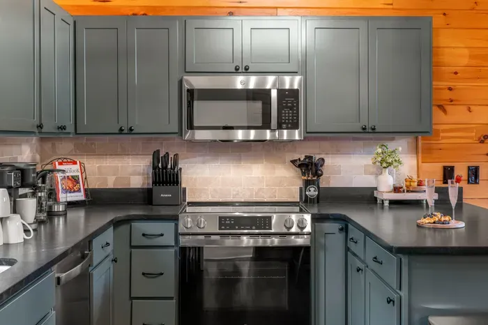 Stylish cabin kitchen with stainless appliances and roomy counters