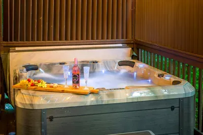 Private outdoor hot tub with a cozy, romantic spa setup