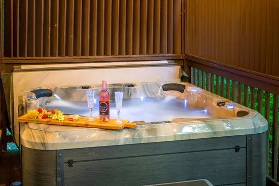 Private outdoor hot tub with a cozy, romantic spa setup