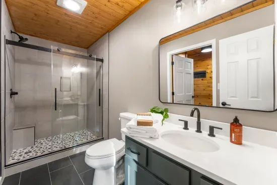 Modern rustic bathroom with walk-in glass shower and stylish vanity