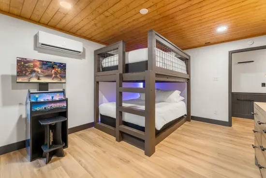 Game room bunk bedroom with arcade fun and cozy modern lodge style