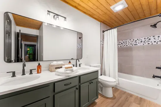 Bright modern bathroom with double vanity and stylish tub-shower combo