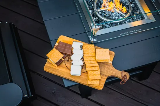 Cozy fire table with s’mores setup for unforgettable outdoor evenings