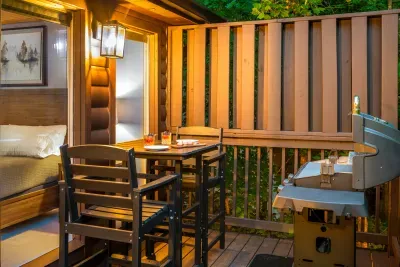 Private covered deck with grill and cozy outdoor dining space