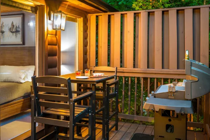 Private covered deck with grill and cozy outdoor dining space