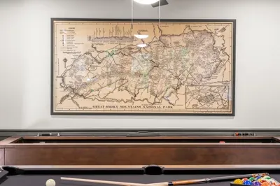 Game room with shuffleboard and vintage Smoky Mountains wall art