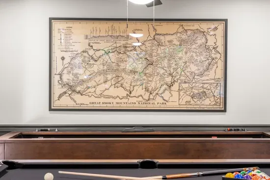 Game room with shuffleboard and vintage Smoky Mountains wall art