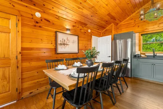 Cozy cabin dining for 6 with vaulted wood ceilings and modern kitchen