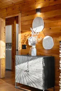 Warm wood-paneled entry with modern décor and convenient in-unit laundry