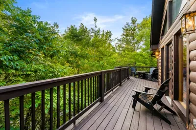 Private forest-view deck with Adirondack chairs and outdoor seating
