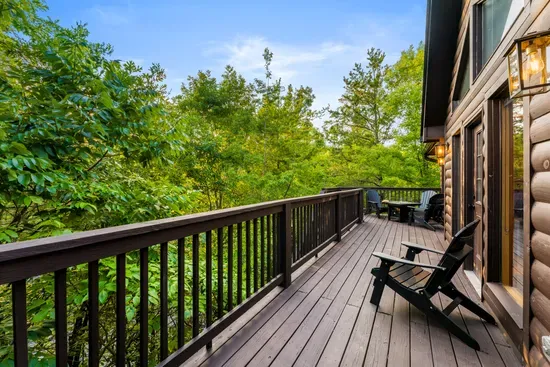 Private forest-view deck with Adirondack chairs and outdoor seating