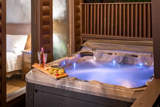 Private hot tub retreat with cozy bedroom access and luxe evening ambiance