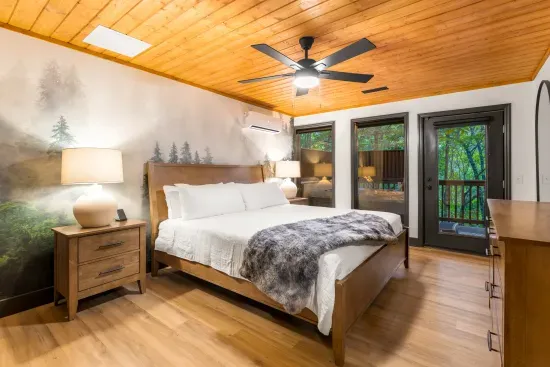 Cozy woodland-inspired bedroom with private deck access