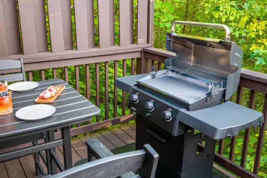Private wooded deck with gas grill and outdoor dining for easy cookouts