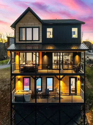 Multi-level outdoor decks with seating and warm lighting, perfect for relaxing and gathering.