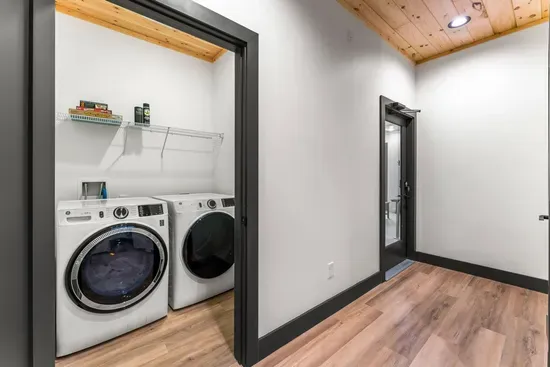 Spacious laundry room with washer and dryer for guest use.