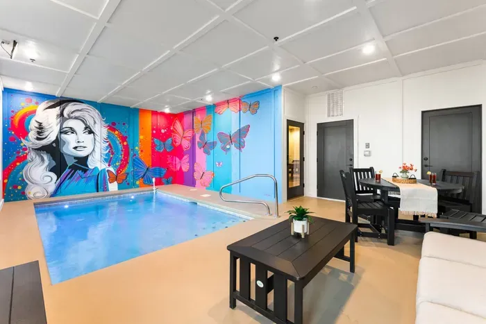 Private indoor pool room with colorful wall murals and ambient lighting for a fun, one-of-a-kind swim experience.