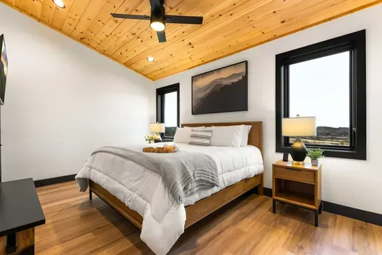 Spacious king bedroom with a private bathroom and fresh linens.