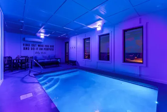 Private indoor pool room with colorful wall murals and ambient lighting for a fun, one-of-a-kind swim experience.