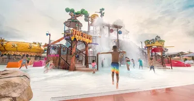 Resort-style water park with giant splash bucket and slides