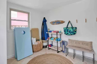 Outdoor cushions, games and beach supplies. Bikes and a beach cart are offered in the shed
