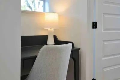 This desk is in the hallway upstairs. Needing an additional work space? There is a folding work desk available for you that is kept under the guest bed.