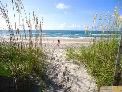 girl-walking-towards-the-ocean-on-beach-2026-09-23-20-48-41-utc