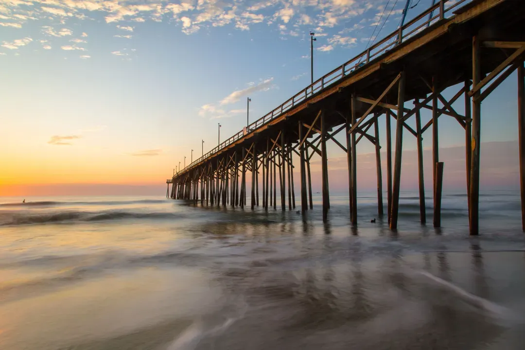low-angle-shot-of-a-beach-pier-under-the-bright-su-2026-09-21-14-58-13-utc