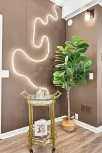 Chic cocktail corner with glowing neon art and stylish bar cart