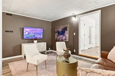 Cozy living room with stylish seating, TV, and warm modern decor