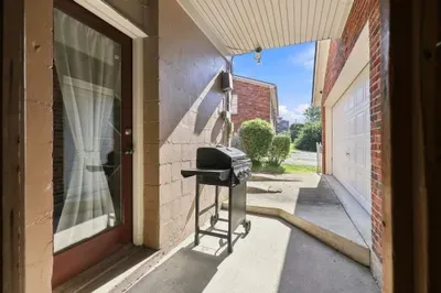 Covered patio with grill for easy outdoor dining and sunny cookouts
