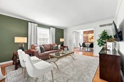 Bright, stylish living room with open dining area and cozy seating