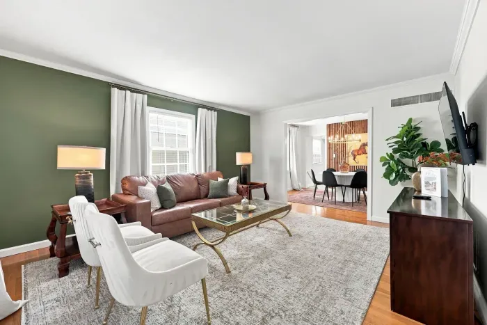 Bright, stylish living room with open dining area and cozy seating
