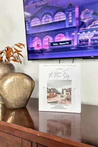Stylish console setup with Roku TV and a thoughtful guest welcome guide