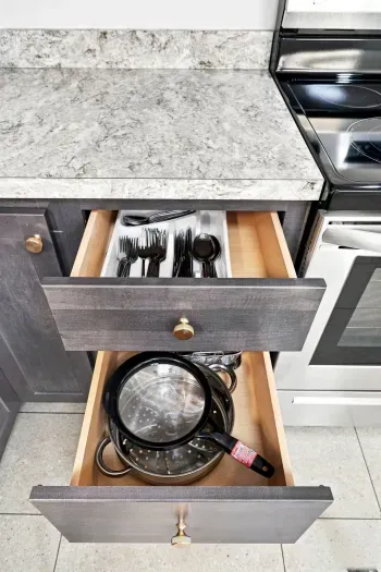 Well-stocked kitchen with organized utensils and cookware by the stove
