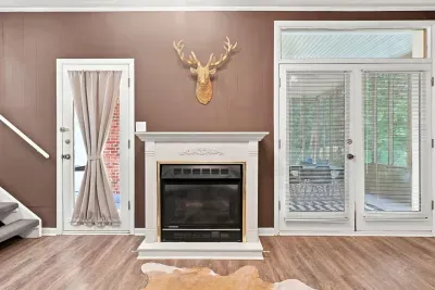 Cozy fireplace lounge with sunroom access and rustic cabin charm