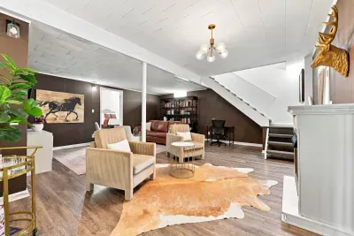 Cozy lounge with workspace, stylish seating, and warm designer touches