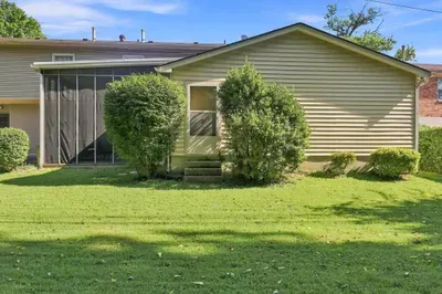 Private entry with screened patio and spacious green lawn