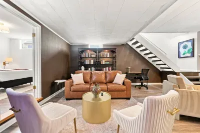 Cozy lower-level lounge with reading nook, workspace, and nearby bedroom