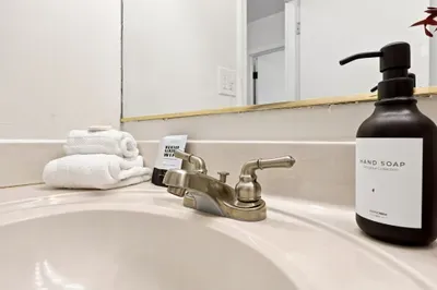 Clean bathroom vanity with fresh towels and thoughtful guest amenities