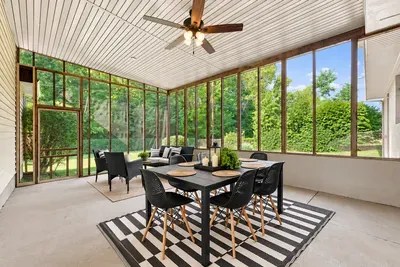 Bright screened porch with dining for 6 and peaceful garden views