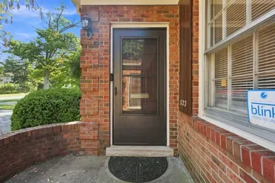 Charming brick entry with covered porch and welcoming curb appeal