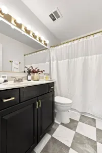 Bright stylish bathroom with modern vanity and chic tiled floors