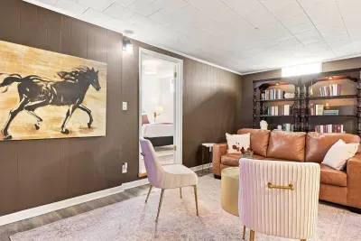 Cozy lounge with leather sofa, bookshelves, and stylish bonus seating