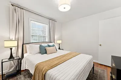 Bright, cozy bedroom with natural light and stylish modern touches