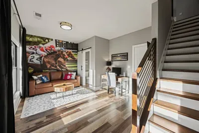 First floor entryway offers a pull-out queen sofa bed, smart tv, and dedicated workspace including an external computer monitor for your convenience. Half bath located on this floor.