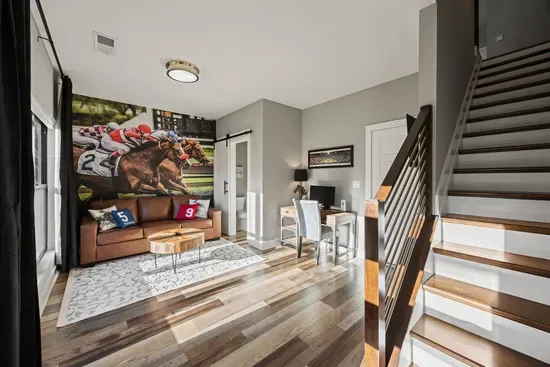 First floor entryway offers a pull-out queen sofa bed, smart tv, and dedicated workspace including an external computer monitor for your convenience. Half bath located on this floor.