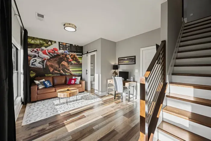 First floor entryway offers a pull-out queen sofa bed, smart tv, and dedicated workspace including an external computer monitor for your convenience. Half bath located on this floor.